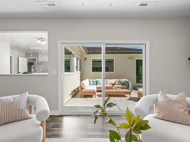 Sliding glass door living area opening to the backyard